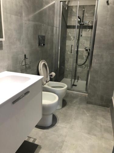 a bathroom with a toilet and a shower at Casa Mare Costa Saracena - Castelluccio in Agnone Bagni