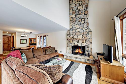 a living room with a couch and a fireplace at Avon Golf Getaway in Avon