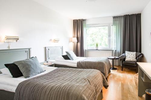 Postel nebo postele na pokoji v ubytování Duvan Hotell & Konferens