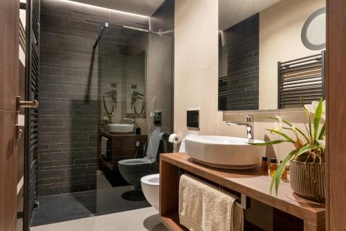 a bathroom with a sink and a toilet at DeGrassi Boutique Garni Hotel Izola in Izola