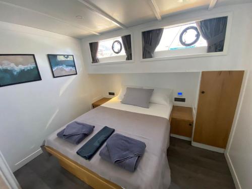 a bedroom with a bed in the middle of a boat at Yacht Room Hotel in Fethiye