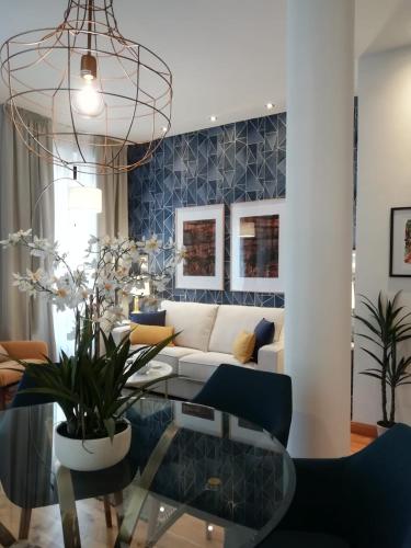 a living room with a white couch and a glass table at tuGuest Isabel la Catolica Apartment in Granada