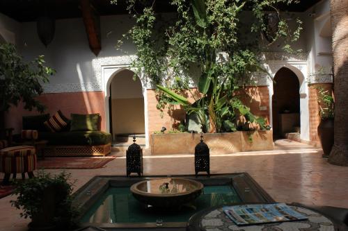 a living room with a fountain in the middle at Riad Jnan El Cadi in Marrakech