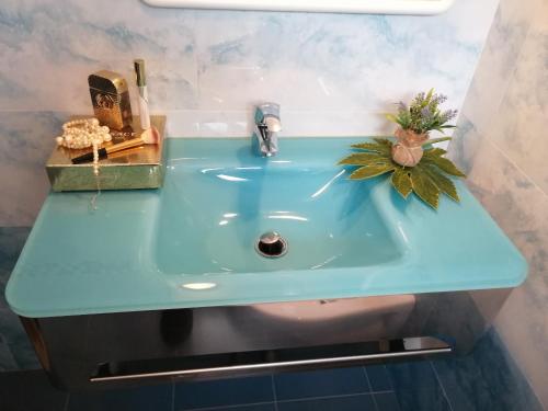 a bathroom sink with a blue counter top at Hotel Riposo in Gatteo a Mare