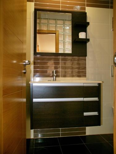 a bathroom with a sink and a mirror at Apartamentos Barrosa II in Portonovo