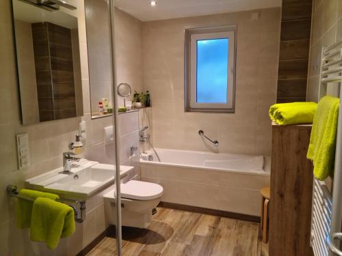 a bathroom with a sink and a tub and a toilet at Ferienwohnung Blickfang in Garmisch-Partenkirchen