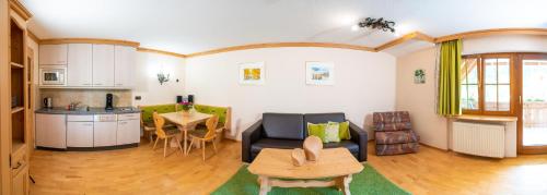 a living room with a couch and a table at Hotel Tannenmühle in Grafenhausen