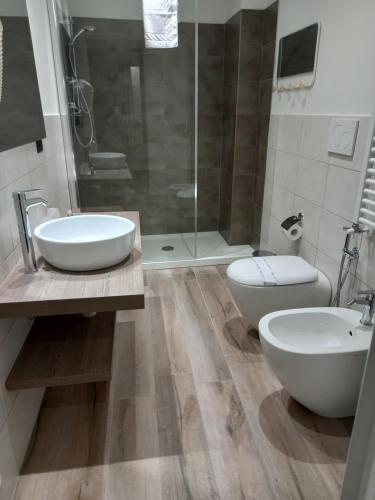 a bathroom with two sinks and a shower and a toilet at Residenza Novi in Novi Ligure