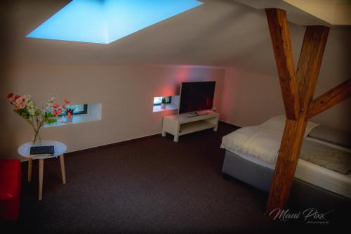 a bedroom with a bed and a tv in a room at Villa Prestige in Zeitz