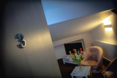 a room with a chair and a table with flowers at Villa Prestige in Zeitz