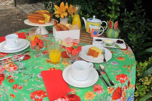 a table topped with plates of food and drinks at No Meio da Natureza - Turismo No Espaco Rural in Vila Nova de Famalicão