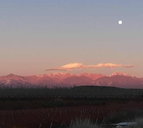 a view of a mountain range with the sun setting at Lodge Atamisque in San José