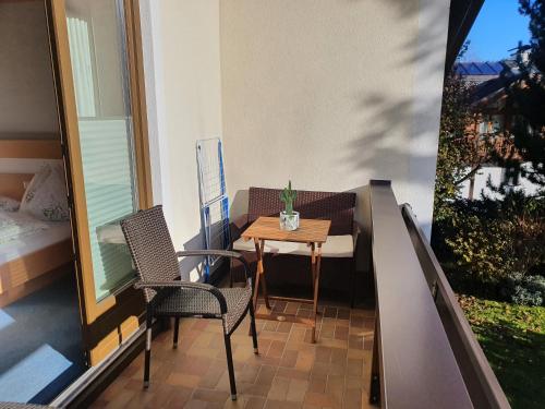 a small balcony with a table and two chairs at Appartements Winter Anita in Flachau
