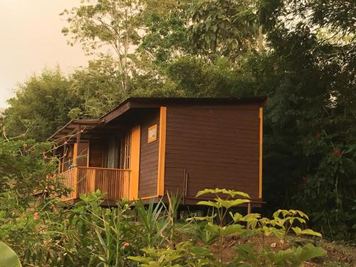 a small wooden cabin in the middle of a forest at Bella Vista Ranch Ecolodge in Turrialba