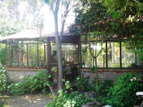 a wooden gazebo in a garden at Hostal Renoir in San Fernando