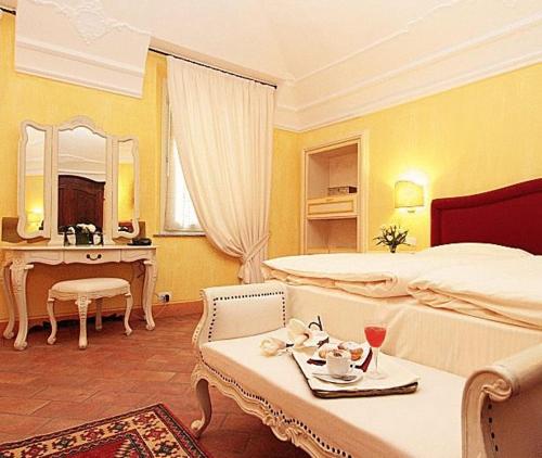 a bedroom with two beds and a table and a mirror at Villa Morneto - Adults Only in Vignale Monferrato