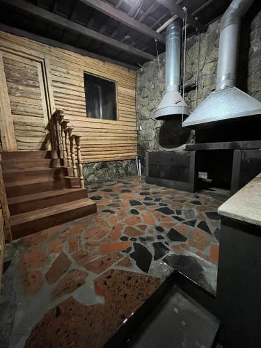 a kitchen with a stone floor and stairs in a room at Old Byurakan Gouest House in Byurakan