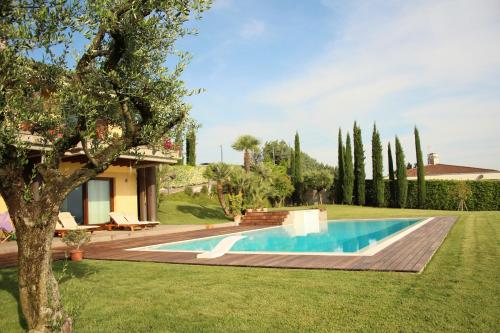 a swimming pool in the yard of a house at B&B Belvedere in Castiglione delle Stiviere