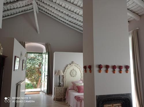 a bedroom with a bed and a fireplace at Finca La Favorita in Constantina