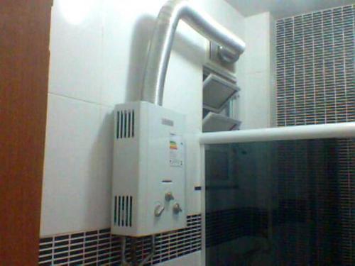a towel dispenser on the wall of a bathroom at Aragão Botafogo Studio in Rio de Janeiro