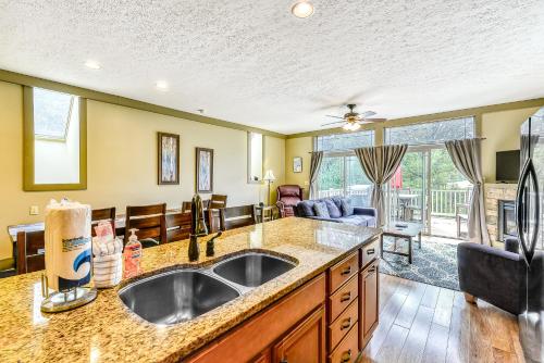 a kitchen with a sink and a living room at Trail's End in McHenry