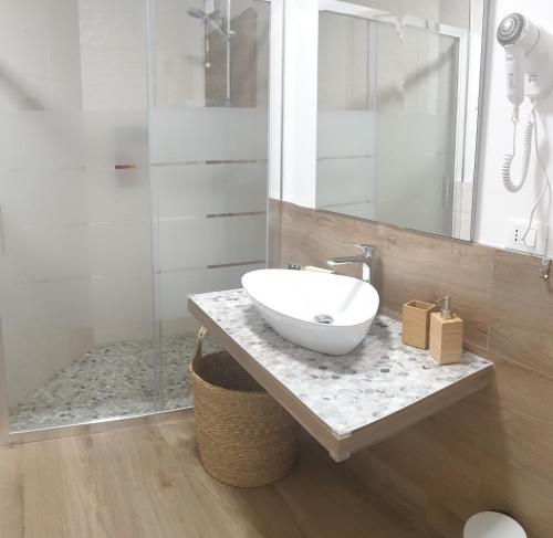 a bathroom with a bowl sink on a counter at B&B La casa di Ale in Verona