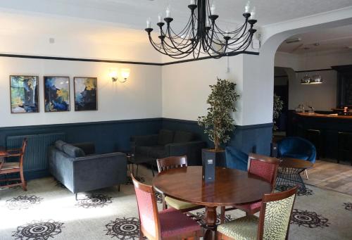 a dining room with a table and chairs at The Coach House Suffolk in Lowestoft