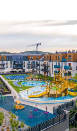 an apartment complex with a water park with a water slide at Meduza w Bel Mare in Międzyzdroje