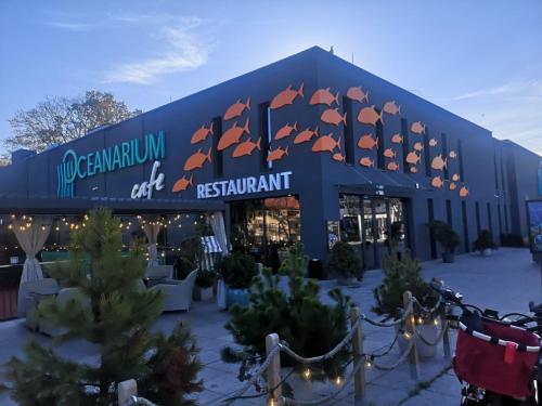 a building with a sign that reads no germanium cafe restaurant at Meduza w Bel Mare in Międzyzdroje