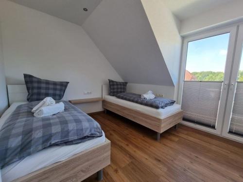 מיטה או מיטות בחדר ב-Ferienhaus Geest und Moor 1
