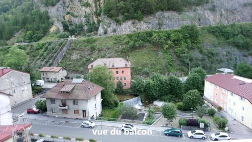 a small town with a mountain in the background at Apart'Bellevue in Morez