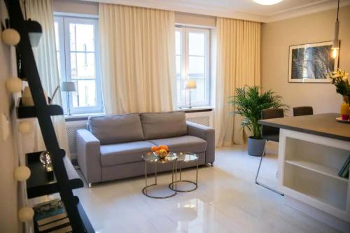 a living room with a couch and a table at Rycerska - Stone Steps Apartments in Warsaw