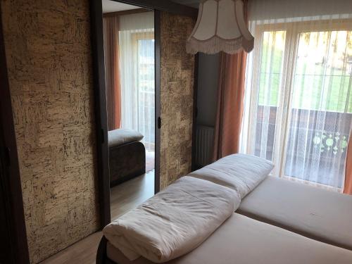a bed in a room with a large mirror at Ferienwohnung Radler in Stumm