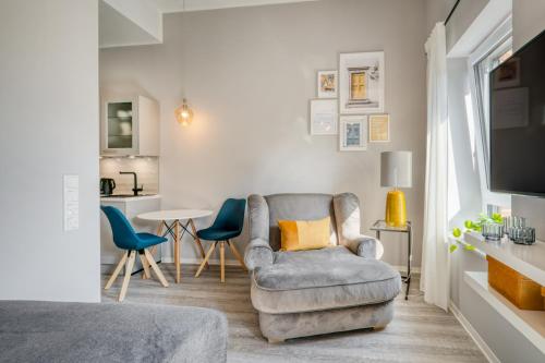 a living room with a couch and a chair at One Moment Boardinghouse - Apartment Harmony in Porta Westfalica