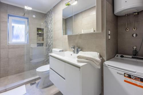 a bathroom with a white sink and a toilet at Apartment Andry 2 in Crikvenica