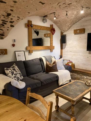a living room with a couch and a table at Two Bedroom Apartment La Voute, Chandon near Meribel - Sleeps 4 Adults or 2 Adults and 3 Children in Les Allues