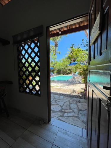 an open door with a view of a pool at Hostel do Ceu in Pipa
