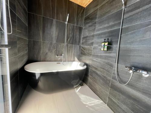 a bathroom with a shower and a toilet and a sink at Bafentian Farmhouse in Guilin