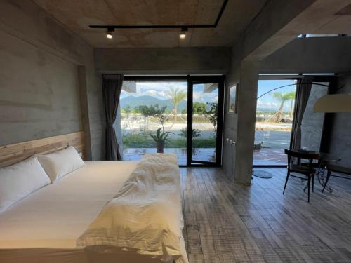 a bedroom with a bed and a view of the ocean at Bafentian Farmhouse in Guilin