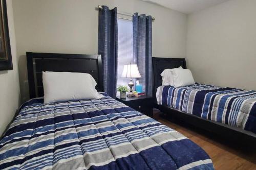 a bedroom with two beds and a window at Diamond of a Deal-708 in Middletown