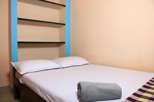 a bedroom with a bed with blue shelving at Paradise corner in Pondicherry