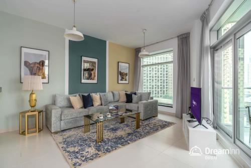 a living room with a couch and a table at Dream Inn Apartments - Loft Towers in Dubai