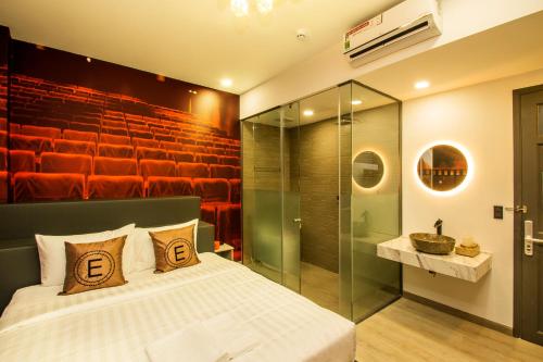 a bedroom with a bed and a glass shower at EROS HOTEL 2 - Love Hotel in Ho Chi Minh City
