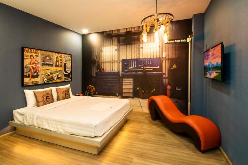 a bedroom with a bed and a chair in it at EROS HOTEL 2 - Love Hotel in Ho Chi Minh City
