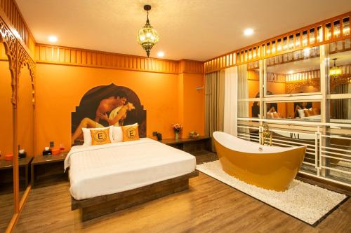a bedroom with a bed and a bath tub at EROS HOTEL 2 - Love Hotel in Ho Chi Minh City