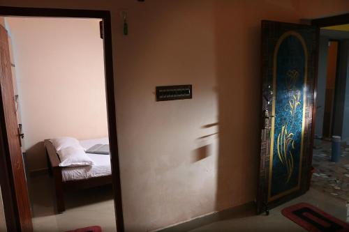 a door to a bedroom with a bed in a room at Paradise corner in Pondicherry
