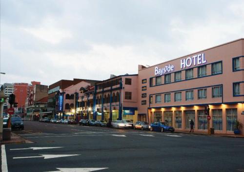 a city street with cars parked in front of a hotel at Bayside Hotel 116 West Street in Durban