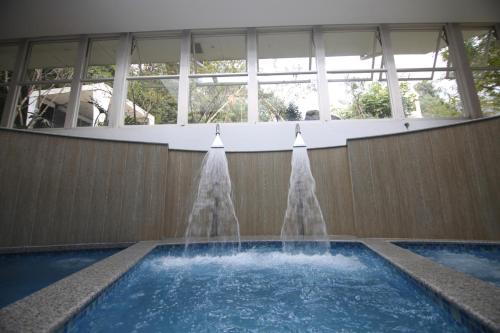 a fountain in a swimming pool in a building at Meraki Holistic Wellness Retreat in Burhānilkantha