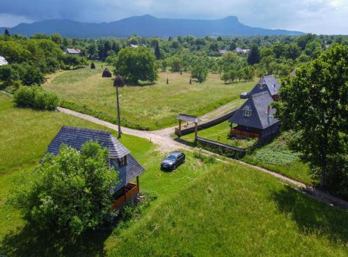 an aerial view of a house and a car in a field at Complex Tradițional Casa din Vale Breb in Breb