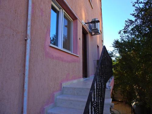 a staircase leading up to a building with a window at Ertunalp Apartment in Mağusa